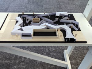 Aerial view of the miniature wood model of a modern building structure, by Alex Shornikov