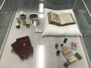 collection of old medical texts and equipment in display case