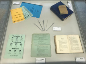 Collection of antique medical texts and metal urinary catheter