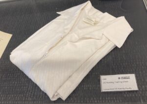 White folded student nurse uniform dress