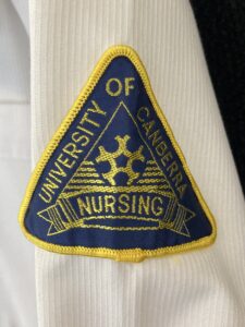 University of Canberra logo on a nursing student shirt