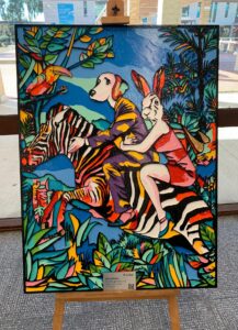 Colour woodcut artwork featuring a dog and a rabbit riding a zebra